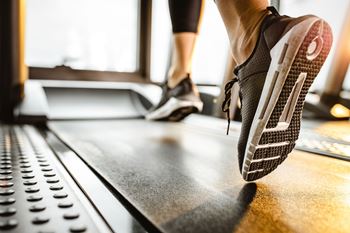 a person running on a treadmill in a gym